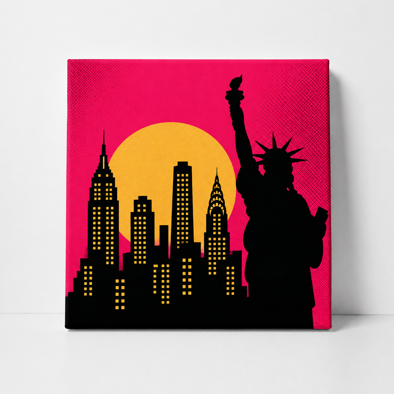 A square canvas wall art print featuring a black silhouette of the Statue of Liberty and New York City skyline against a bright pink and yellow sunset background.